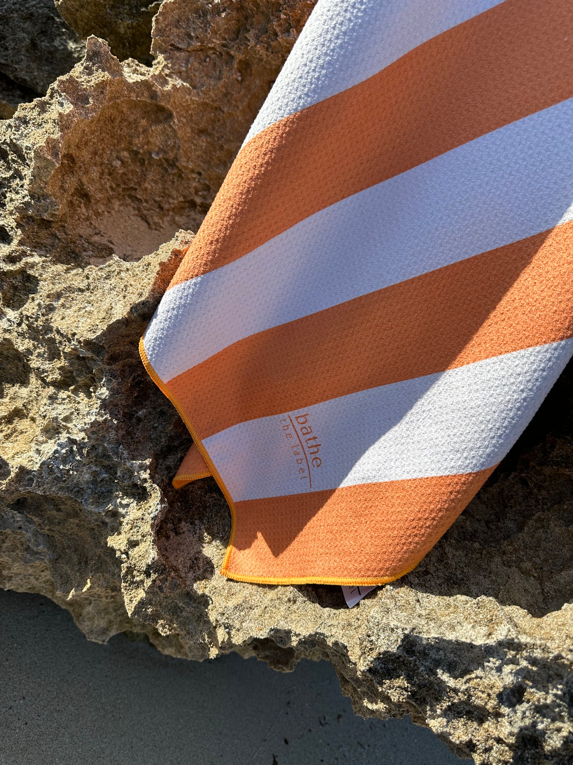 Sand-free beach towel in Apricot Crush colour, made from recycled materials for eco-conscious beachgoers. Our minimalist design towels are quick-dry, ultra-absorbent, lightweight and compact, and come in a convenient neoprene water resistant pouch for easy transport or storing your sunnies, keys etc. while enjoying the outdoors. Sizes available: Kids, Regular and XL Share Towel