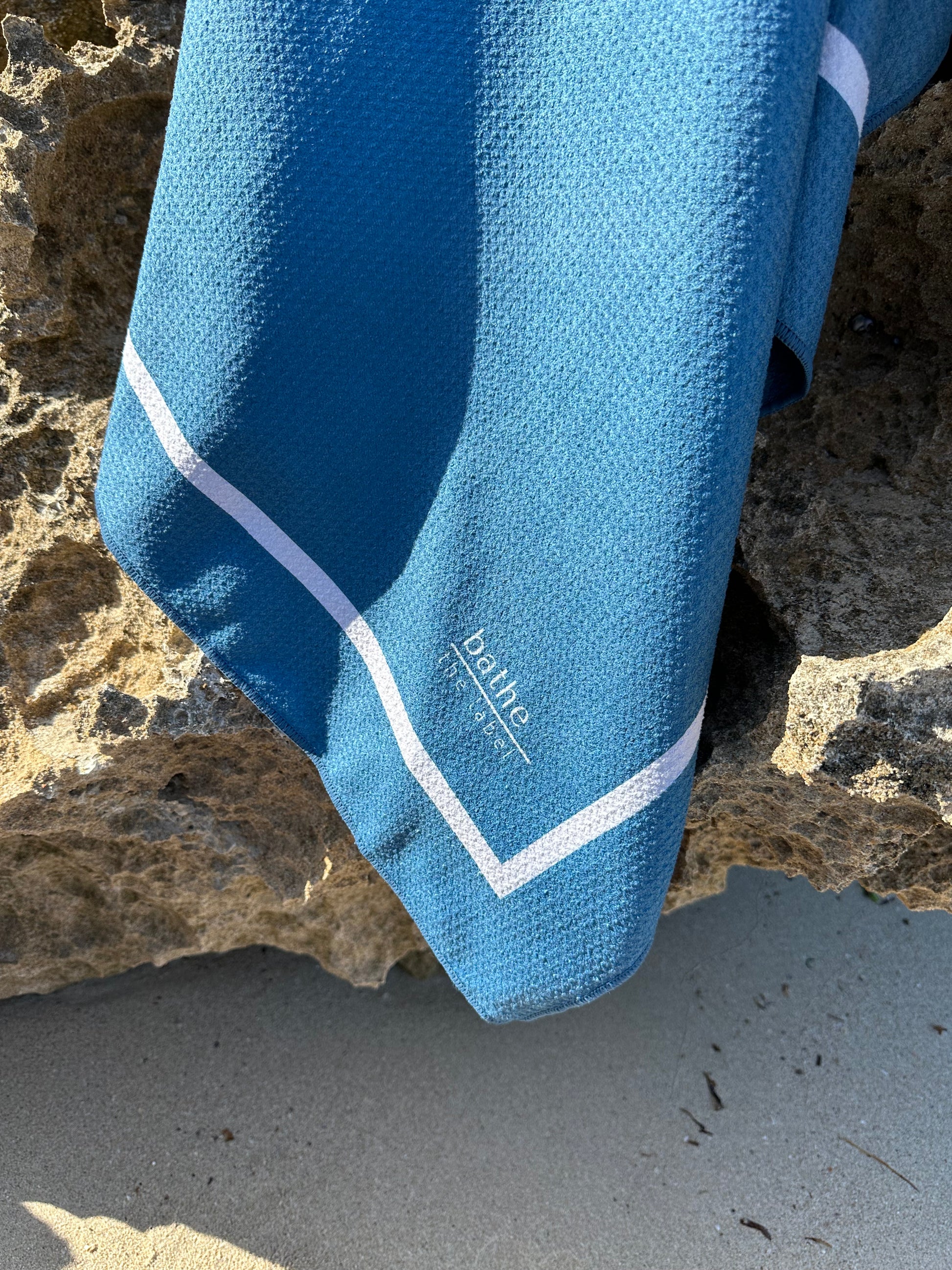 Sand-free beach towel in Deep Ocean blue green colour, made from recycled materials for eco-conscious beachgoers. Our minimalist design towels are quick-dry, ultra-absorbent, lightweight and compact, and come in a convenient neoprene water resistant pouch for easy transport or storing your sunnies, keys etc. while enjoying the outdoors. Sizes available: Kids, Regular and XL Share Towel