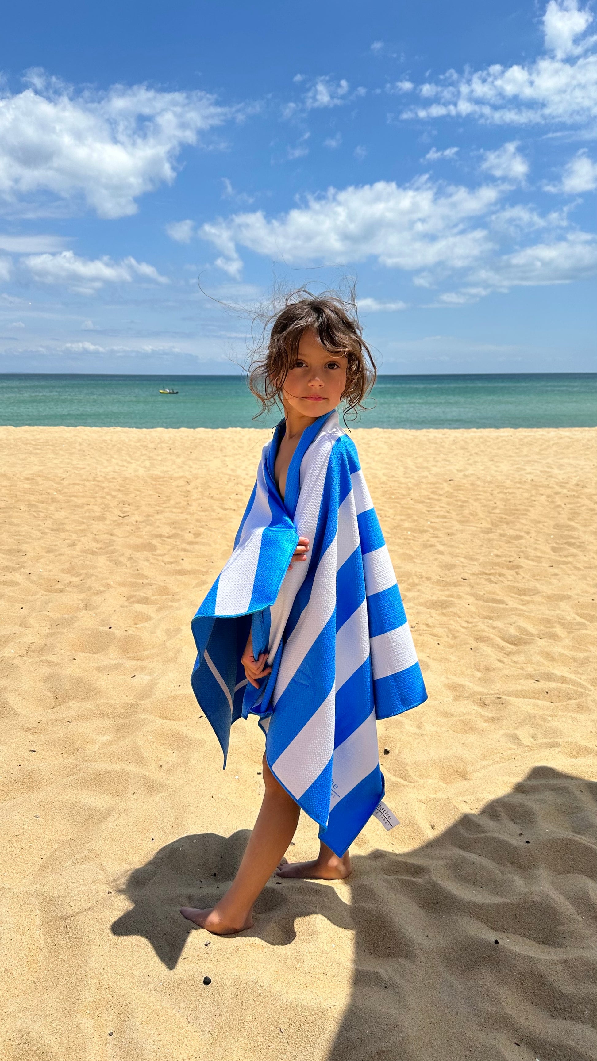 Kids size sand-free beach towel in blue colour, made from recycled materials for eco-conscious beachgoers. Our minimalist design towels are quick-dry, ultra-absorbent, lightweight and compact, and come in a convenient neoprene water resistant pouch for easy transport or storing your sunnies, keys etc. while enjoying the outdoors.