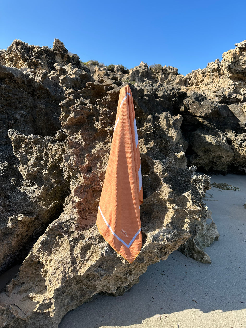 Sand-free beach towel in Apricot Crush colour, made from recycled materials for eco-conscious beachgoers. Our minimalist design towels are quick-dry, ultra-absorbent, lightweight and compact, and come in a convenient neoprene water resistant pouch for easy transport or storing your sunnies, keys etc. while enjoying the outdoors. Sizes available: Kids, Regular and XL Share Towel