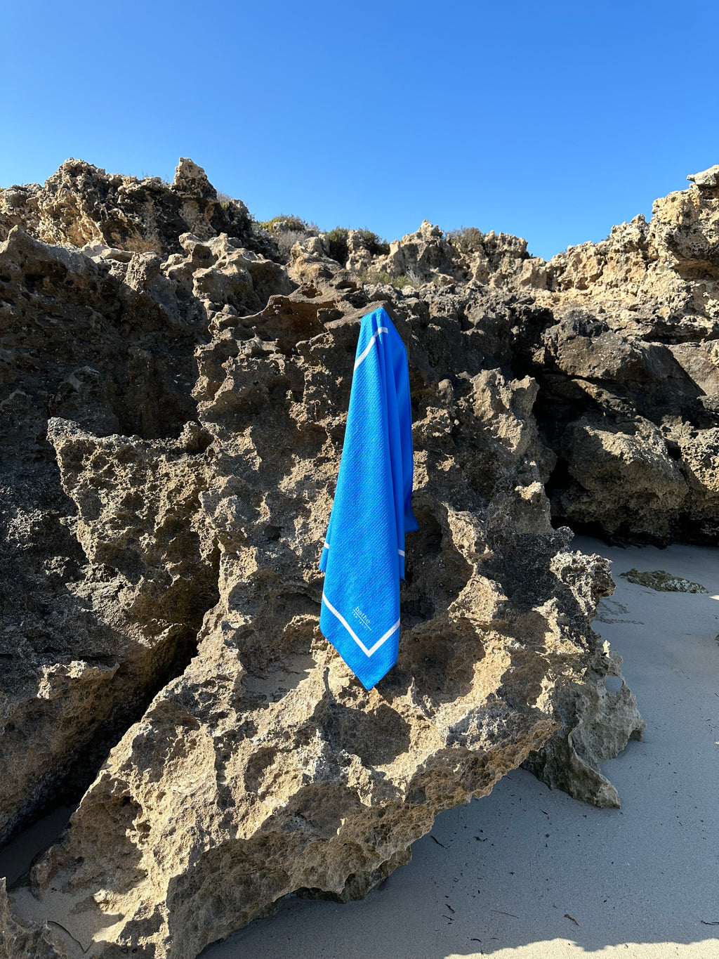 Kids size sand-free beach towel in blue colour, made from recycled materials for eco-conscious beachgoers. Our minimalist design towels are quick-dry, ultra-absorbent, lightweight and compact, and come in a convenient neoprene water resistant pouch for easy transport or storing your sunnies, keys etc. while enjoying the outdoors.