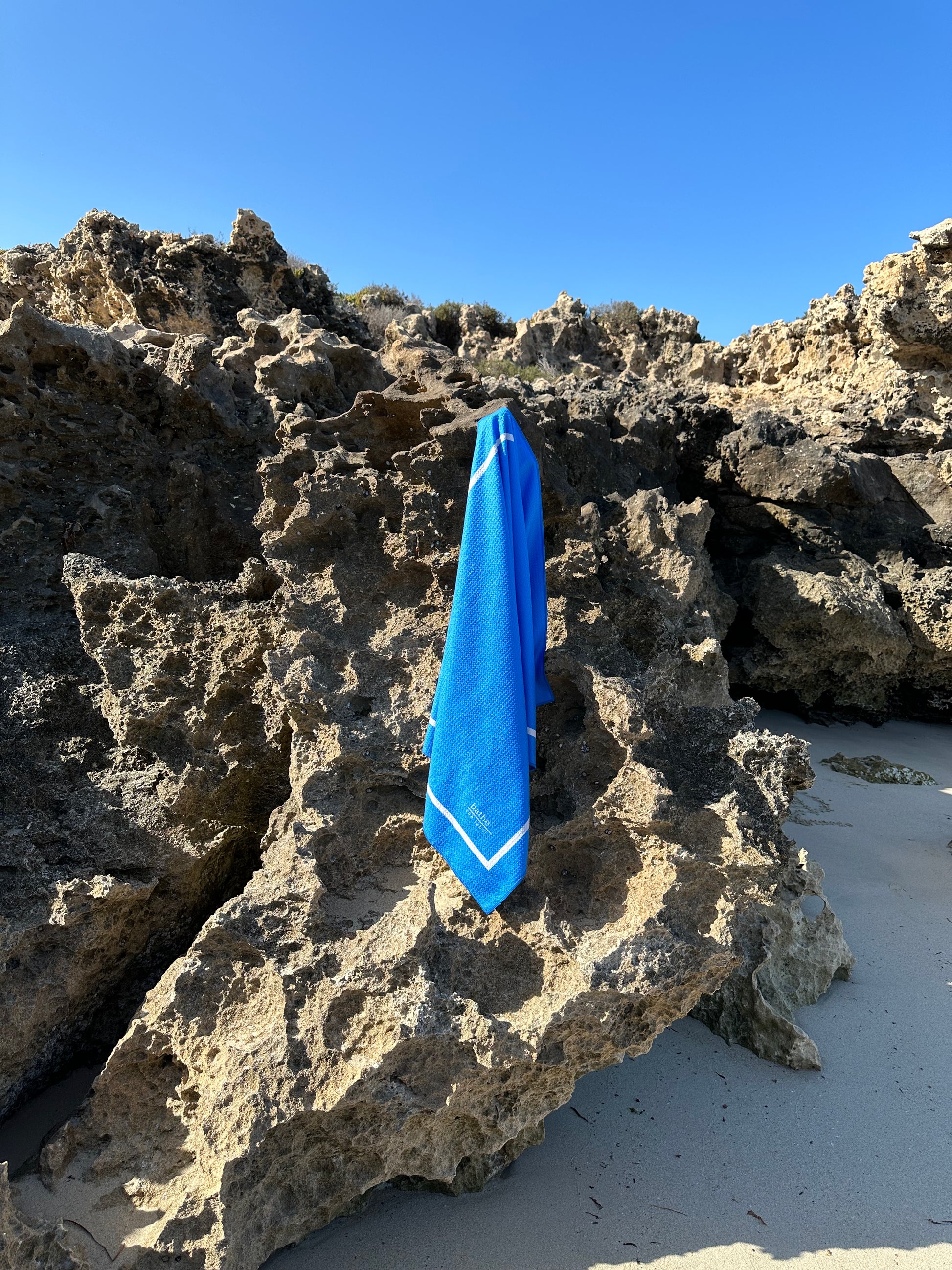 Kids size sand-free beach towel in blue colour, made from recycled materials for eco-conscious beachgoers. Our minimalist design towels are quick-dry, ultra-absorbent, lightweight and compact, and come in a convenient neoprene water resistant pouch for easy transport or storing your sunnies, keys etc. while enjoying the outdoors.