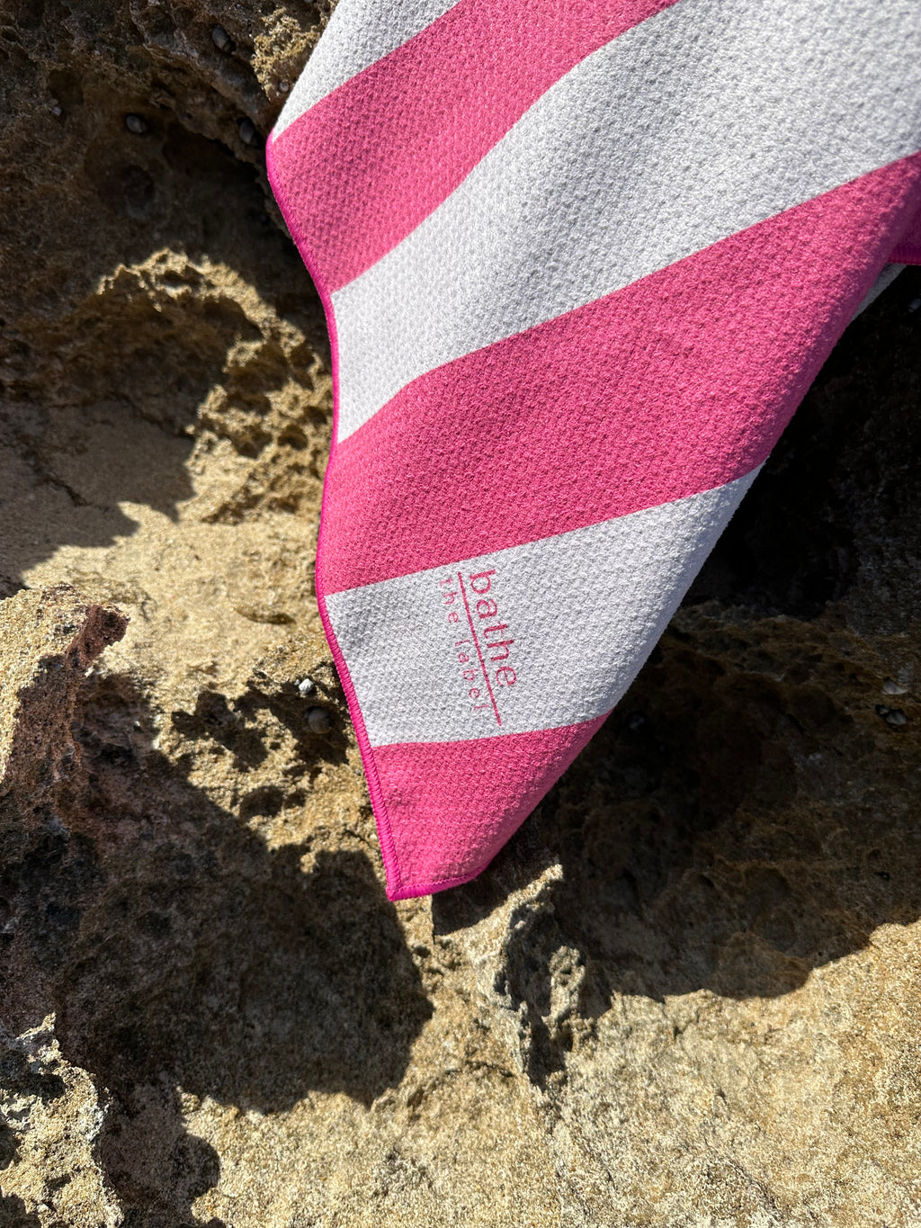 Kids size sand-free beach towel in pink colour, made from recycled materials for eco-conscious beachgoers. Our minimalist design towels are quick-dry, ultra-absorbent, lightweight and compact, and come in a convenient neoprene water resistant pouch for easy transport or storing your sunnies, keys etc. while enjoying the outdoors.