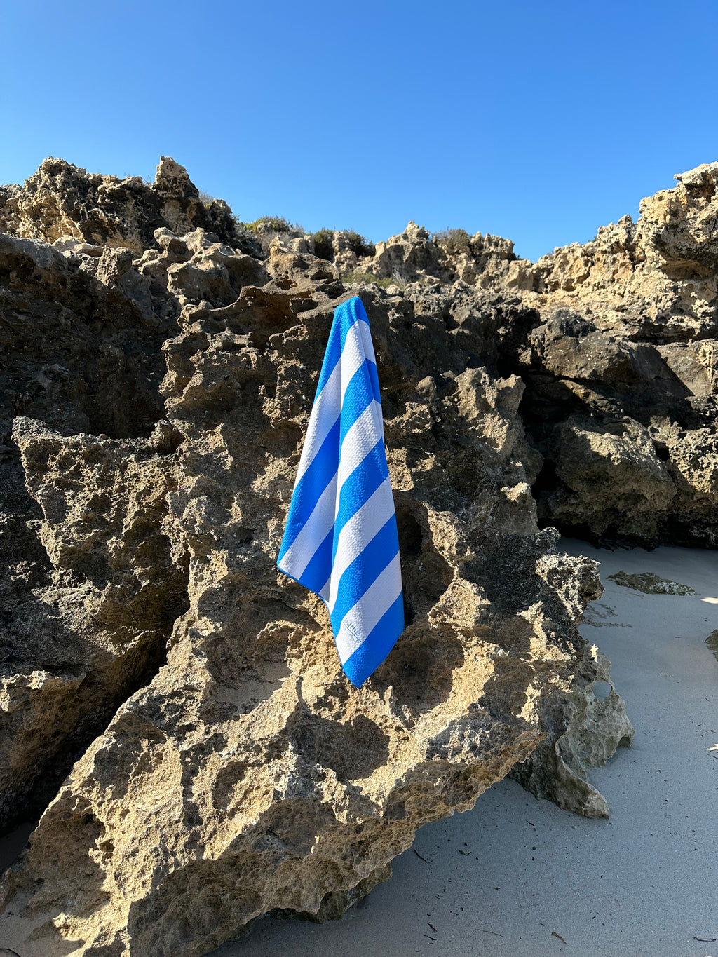 Kids size sand-free beach towel in blue colour, made from recycled materials for eco-conscious beachgoers. Our minimalist design towels are quick-dry, ultra-absorbent, lightweight and compact, and come in a convenient neoprene water resistant pouch for easy transport or storing your sunnies, keys etc. while enjoying the outdoors.
