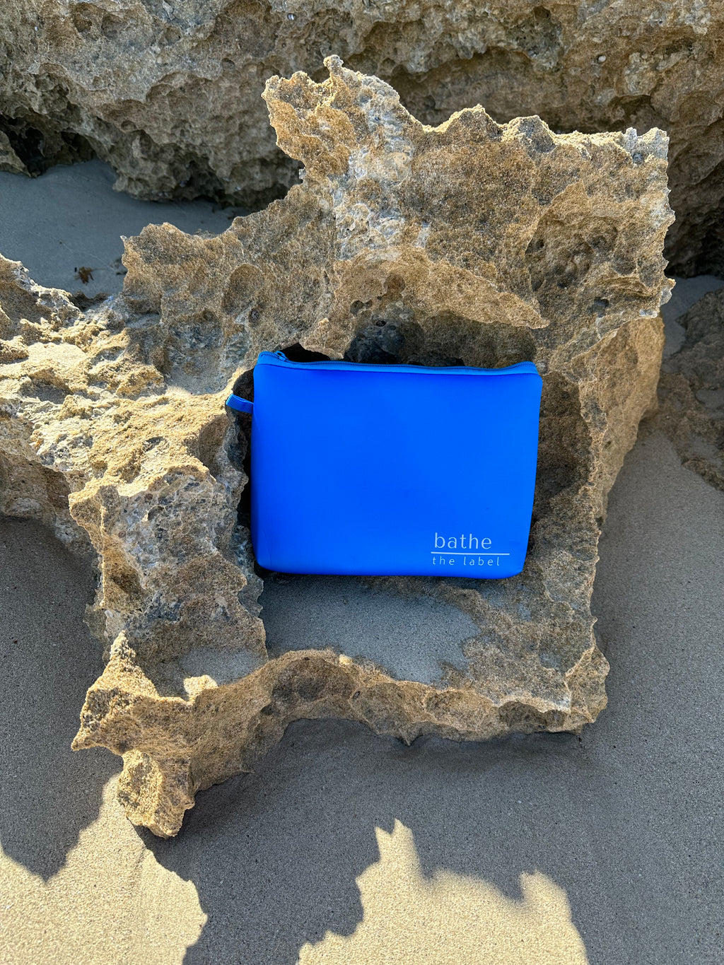 Kids size sand-free beach towel in blue colour, made from recycled materials for eco-conscious beachgoers. Our minimalist design towels are quick-dry, ultra-absorbent, lightweight and compact, and come in a convenient neoprene water resistant pouch for easy transport or storing your sunnies, keys etc. while enjoying the outdoors.