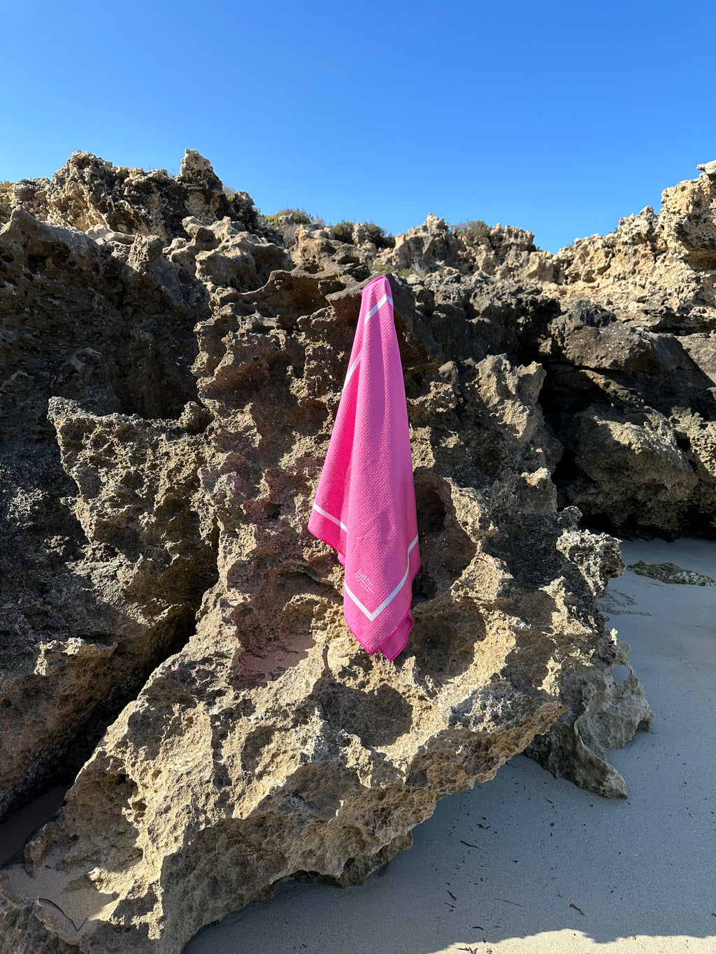 Kids size sand-free beach towel in pink colour, made from recycled materials for eco-conscious beachgoers. Our minimalist design towels are quick-dry, ultra-absorbent, lightweight and compact, and come in a convenient neoprene water resistant pouch for easy transport or storing your sunnies, keys etc. while enjoying the outdoors.