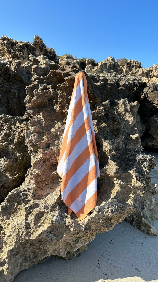 Sand-free beach towel in Apricot Crush colour, made from recycled materials for eco-conscious beachgoers. Our towels are quick-dry, ultra-absorbent, lightweight and compact, and come in a convenient neoprene water resistant pouch for easy transport or storing your sunnies, keys etc. while enjoying the outdoors. SIze: regular. Also available in XL Share size. 